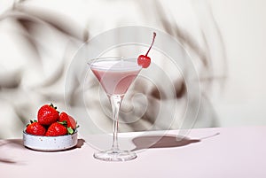 Bounty martini summer alcoholic cocktail drink with vodka, liqueur, cream, syrup, strawberries and ice in glass with cocktail