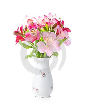 Bouquet of Alstroemeria flowers in old porcelain vase isolated on white background