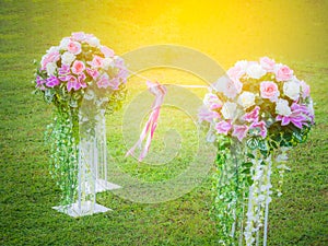 Bouquet of artificial flowers On the lawn. Link together with a ribbon and a bow in the middle