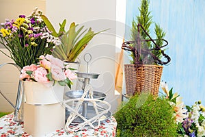 Bouquet of artificial rose and real flowers in a pot with plant