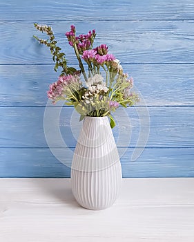 Bouquet of autumn flowers, vase, design vintage elegance composition on a wooden background