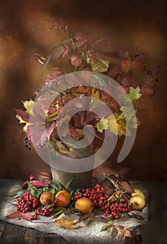 Bouquet of autumn leaves in a jug.