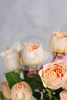 Bouquet of beautiful fresh roses on grey background, closeup.