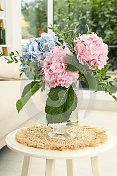 Bouquet with beautiful hortensia flowers on table in living room