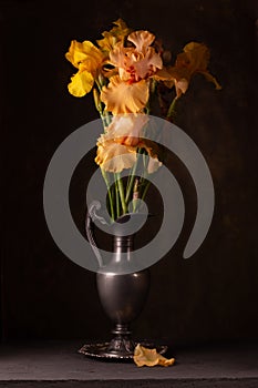 Bouquet of beautiful irises in an old pewter jug
