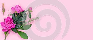 Bouquet of beautiful peonies on pink paper background. Creative spring concept. Festive greeting card