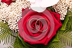 Bouquet with beautiful roses and wedding rings