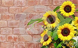 Bouquet of beautiful sunflowers on brick background