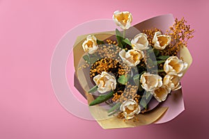 Bouquet with beautiful tulips and mimosa flowers on pink background, top view. Space for text