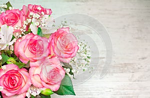 A bouquet of beautiful wedding flowers on a white wooden background. place for text
