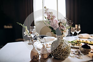 Bouquet of  beautiful wild flowers in vase on the table. Wedding decoration ideas