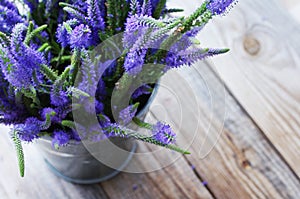 Bouquet of blue wild summer flowers in a metal bucket