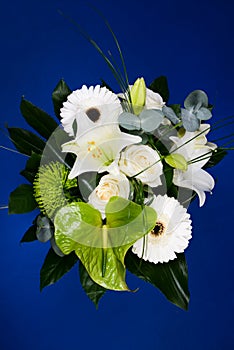 Bouquet bunch of beautiful white flowers with white roses, lily and daisy