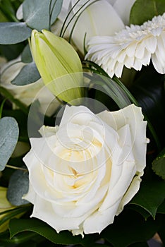 Bouquet bunch of beautiful white flowers with white roses, lily and daisy