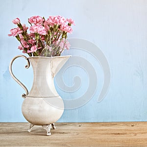 Bouquet of Carnation flowers in the vintage white vase