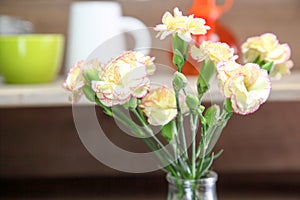 Bouquet of carnation in a glass bottle