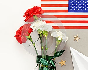 Bouquet of carnations, American flag and paper plane