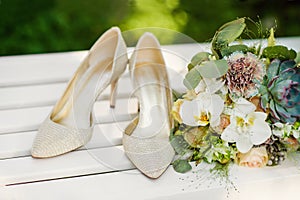 A bouquet of colorful flowers lies on a white bench.