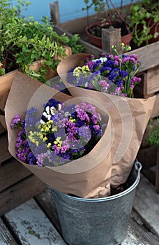 Bouquet colorful flowers Limonium or Statice (sea-lavender, caspia or marsh-rosemary) in craft paper