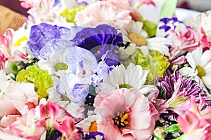 bouquet of colorful flowers: orchids, white and pink chrysanthemums, pink and purple eustomas
