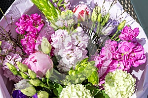 Bouquet with colorful spring-summer flowers. Pink snapdragons, peonies and white snowball in beautiful arrangement.