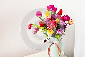 Bouquet of colorful tulips in white can