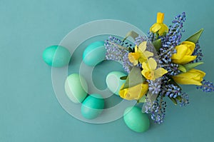 Bouquet of daffodils, tulips and Muscari.Easter. Easter eggs are blue and turquoise.