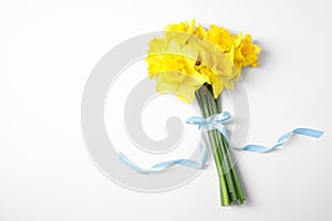 Bouquet of daffodils on white background, top view.