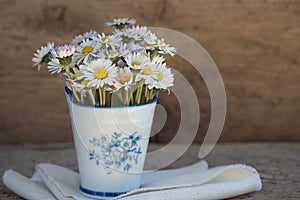 Bouquet of daisies is elegantly displayed in a ceramic pot