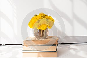 A bouquet of dandelions in a vase in a cozy white room. home spending time concept