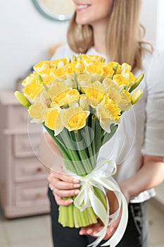 Bouquet of delicate yellow color. beautiful luxury bunch of mixed flowers in womans hand. the work of the florist at a