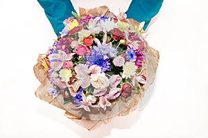 Bouquet with different colors in the hands of a man