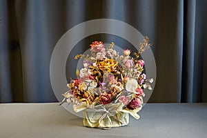 Bouquet of dried flowers herbarium on a grey background