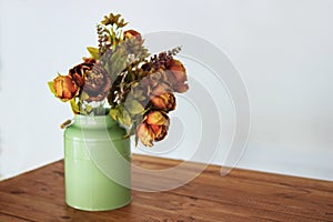 Bouquet of dried flowers in vase on table and light background. A bouquet of dried flowers in a vase. Dry flowers