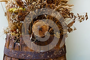 Bouquet of dried flowers in a wooden barrel