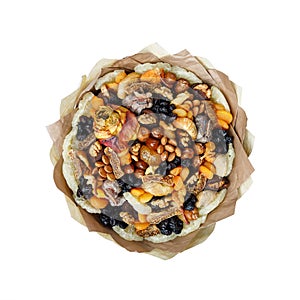 Bouquet of dried fruits, almonds and waxed roses as a gift on a white background