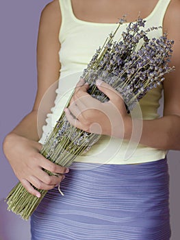 Bouquet of dried lavender in the hands of a young girl