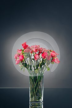 Bouquet of dried pink roses in a vase