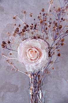 Bouquet of dried wild flowers on the background of a concrete wall