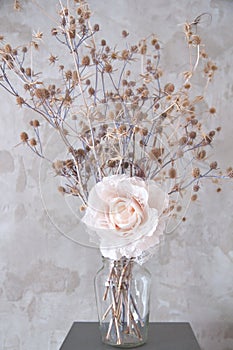 Bouquet of dried wild flowers on the background of a concrete wall