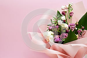 bouquet of dying flowers on pink background