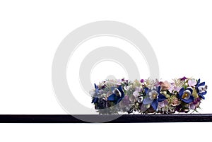 Bouquet of flowers on a brown desk with isolated background