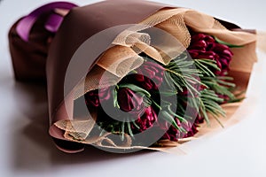 Bouquet of flowers in burgundy package