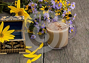 Bouquet of flowers, cappuccino, casket and petals