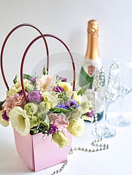 A bouquet of flowers, champagne and two glasses,, basket with flowers, mother`s day, lovers` day, women`s gift set, gift