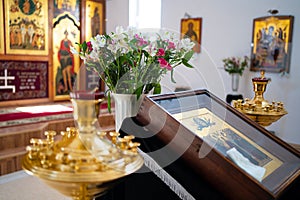 Bouquet of flowers in Church lamps icons on ambo