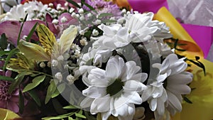 Bouquet of flowers close-up. Floral background. Purple, white and blue flowers as a gift. Chamomile, aster, iris