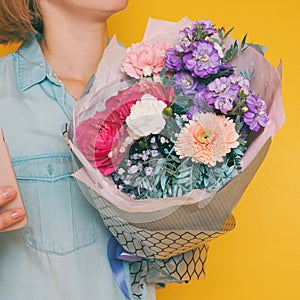 A bouquet of flowers in the hands of a woman