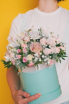 A bouquet of flowers in the hands of a woman