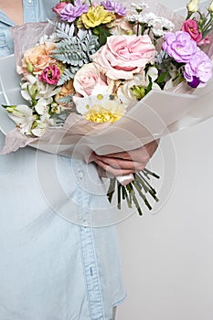 A bouquet of flowers in the hands of a woman